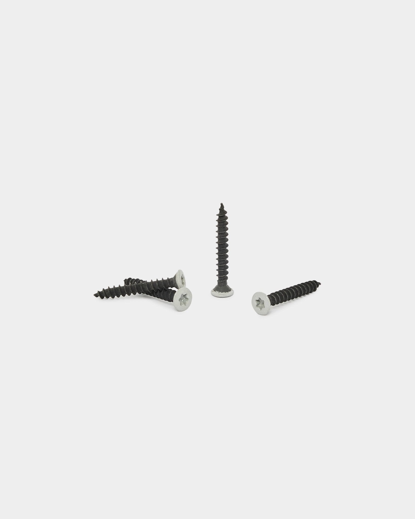 Four grey WoodUpp screws from the Installation Products set (100 pcs) shown on a plain white background; three are horizontal and one stands upright.